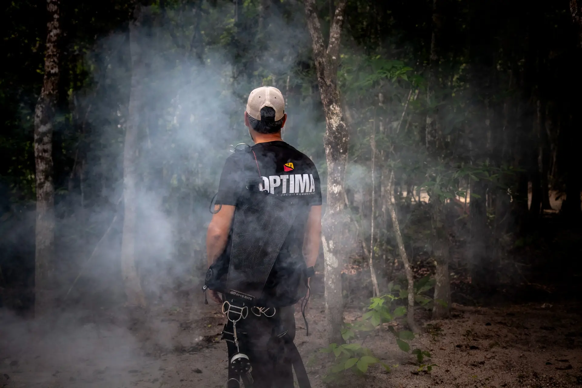Dive Rite diver carrying equipment through a cenote entrance